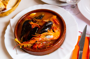 Typical homemade Catalan salsa suquet - thick seafood stew with shrimps and mussels traditionally...