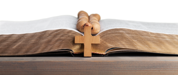 Rosary beads on open bible on wooden table