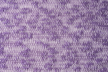 Close up background of knitted wool fabric made of viscose yarn. Mix of purple and white color, melange wool knitwear texture. Abstract knitted jersey background. Fabric abstract backdrop, wallpaper