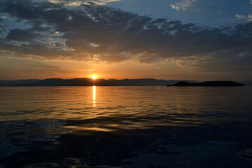 Fototapeta na wymiar View of Albania and Lazareto island from a sailboat during sunrise.