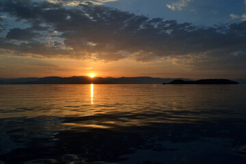 View of Albania and Lazareto island from a sailboat during sunrise.
