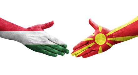 Handshake between North Macedonia and Hungary flags painted on hands, isolated transparent image.