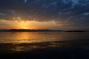 View of Albania and Lazareto island from a sailboat during sunrise.