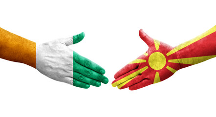 Handshake between North Macedonia and Ivory Coast flags painted on hands, isolated transparent image.