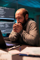 Young man feeling cold and drinking cup of coffee, using hot beverage to get warm in office late at...