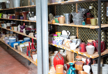 Rows with clay pots for plants in garden store. High quality photo