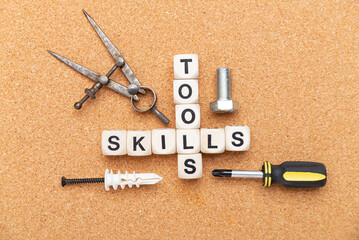 words TOOLS and SKILLS are written on wooden blocks. housework tools. business concept of skills...