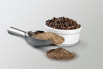 Black pepper seasonings in spoon on the desk