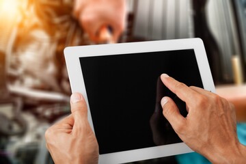 Mechanic worker with digital tablet on car background