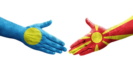 Handshake between North Macedonia and Palau flags painted on hands, isolated transparent image.