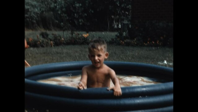 Brothers in the Kiddie Pool 1954 - Two brothers splash in a kiddie pool in their suburban Chicago home in 1954. 