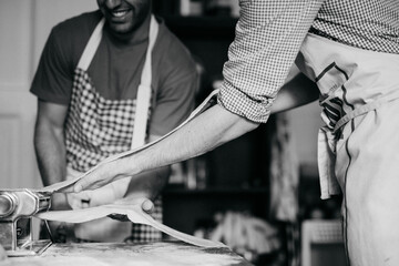 two persons making handmade pasta