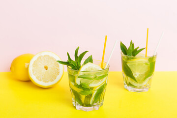 Mojito summer refreshing cocktail with ice and mint. mojito cocktail with lime, lemon and mint in a tall glass with a stick
