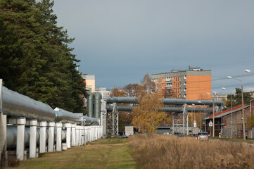 Fototapeta na wymiar pipeline, in the photo the pipeline is close-up, in the background the city and buildings