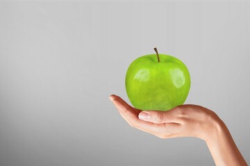 Human's hand with fresh ripe apple. Dietary food