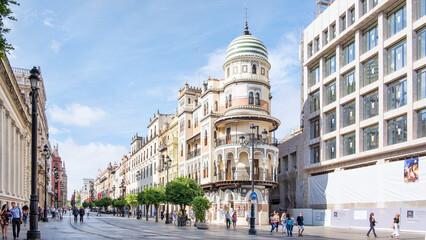 Street view of pedestrians walking along Avda. de la Costitucion, major avenue in the Casco Antiguo...