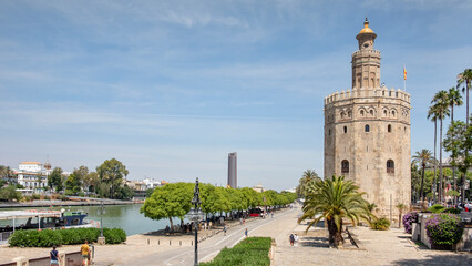 Fototapeta na wymiar The Golden Tower located on the left bank of Guadalquivir River, historic military observation tower and Spanish cultural heritage monument known as Torre del Oro, Seville, Andalusia, Spain