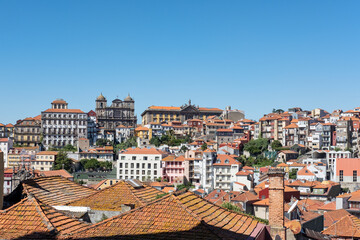 Fototapeta na wymiar Ample views from the lookout Terreiro da Se, near the famous Romanesque cathedral, towards historical buildings, churches and the traditional colorful rooftops in Porto, Portugal