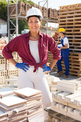 Portrait of positive asian female worker supervisor posing at a construction store