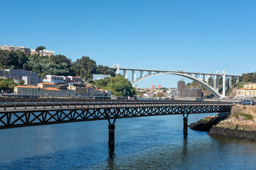 Views of the Douro riverside with Viaducto do Cais das Pedras in the foreground and Ponte da Arrabida, one of the six arch bridges in the city, in the background, Porto, Portugal