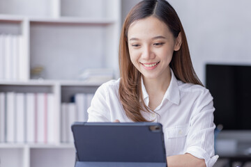 Young business multiethnic Asian women Accounting using calculating tablet income-expenditure and analyzing real estate investment data report Financial and tax systems in workplace office.
