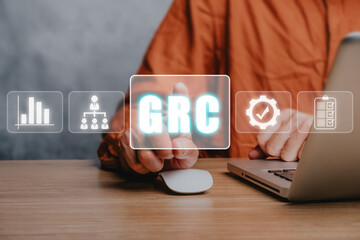 GRC, Governance Risk and Compliance concept, Business person using laptop computer and hand...
