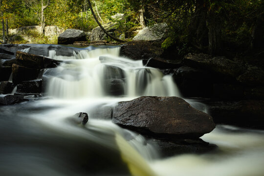 Cascades In The Forest Around A Big Rock In The Portneuf Natural Regional Park. Chute Sur La Rivière Noire, Parc Naturel Régional De Portneuf