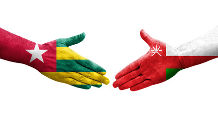 Handshake between Oman and Togo flags painted on hands, isolated transparent image.