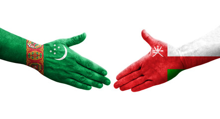 Handshake between Oman and Turkmenistan flags painted on hands, isolated transparent image.