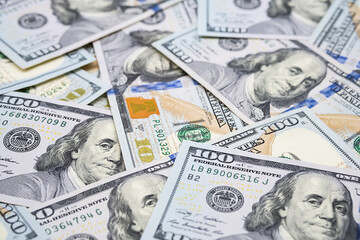 One hundred dollar bills. U.S. paper currency background.