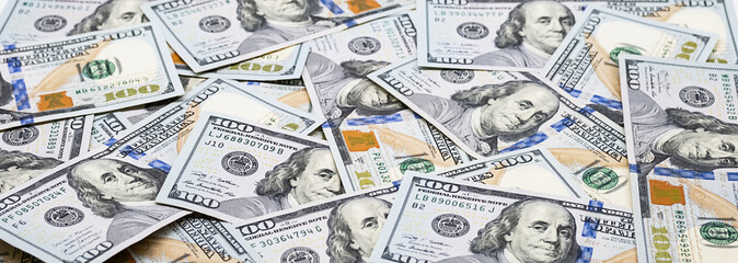 One hundred dollar bills. U.S. paper currency background.