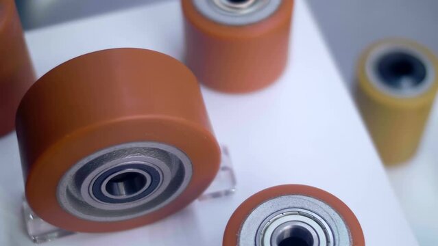 Samples of new powerful rollers for industrial trolley at the exhibition of industrial equipment. Shot in motion. Closeup