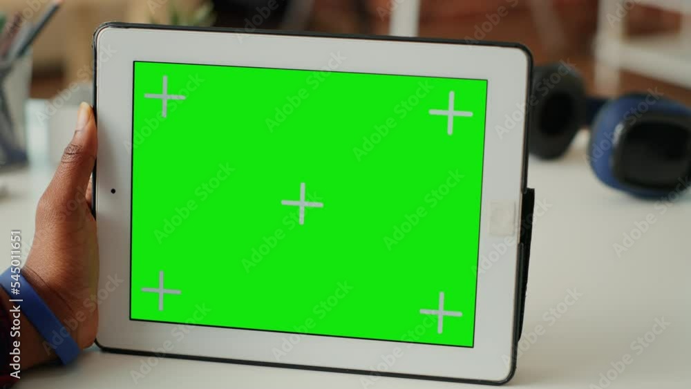 Aufkleber modern person looking at horizontal greenscreen display on tablet at home, using wireless gadget wit