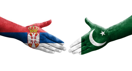 Handshake between Pakistan and Serbia flags painted on hands, isolated transparent image.