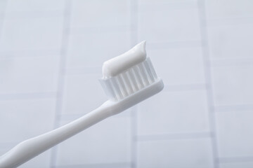 Fototapeta na wymiar タイルに置かれた歯ブラシ　toothbrush