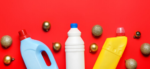Cleaning supplies and decor on red background. Christmas cleanup