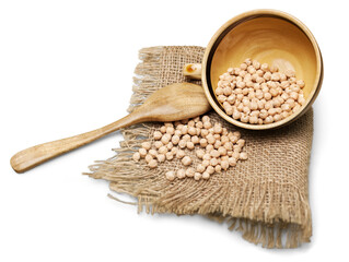 Dry legumes on sack cloth with bowl and wooden spoon