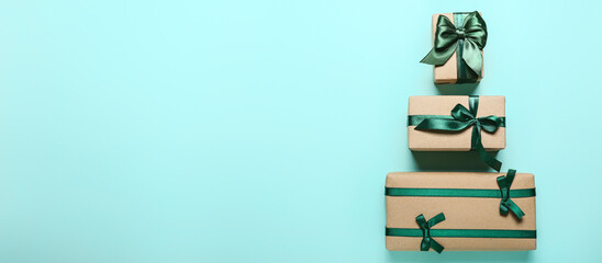 Christmas gifts on light blue background with space for text