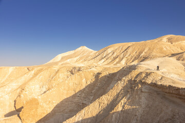 Fototapeta na wymiar Gorgeous aerial drone top bird's eye view of incredible golden desert mountains of tzin river. desert in Israel