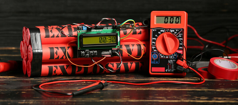 Bomb with timer and tools on wooden background