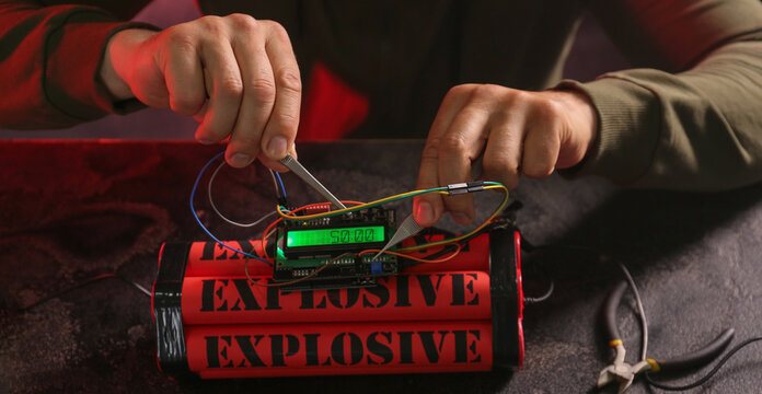 Man defusing bomb at table, closeup