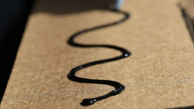 Craftsmen use black silicone glue. for general and industrial applications