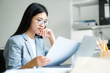 Young asian business woman or student working online on computer laptop.