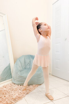 Rehearsal: little ballerina practicing ballet moves	