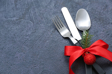 Stylish table setting for Christmas celebration on dark background