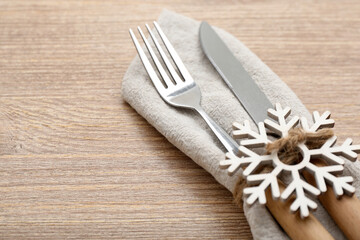 Fototapeta na wymiar Stylish cutlery for Christmas celebration on wooden background
