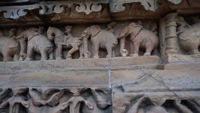 Woman Touch The Carved Elephant Artworks On Khajuraho Temple In Chhatarpur, Madhya Pradesh, India. - zoom out