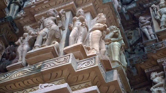 Outer Wall Of Hindu Temple With Kamasutra Sculptures In Khajuraho, Madhya Pradesh, India. - Low-Angle, Pan Right

