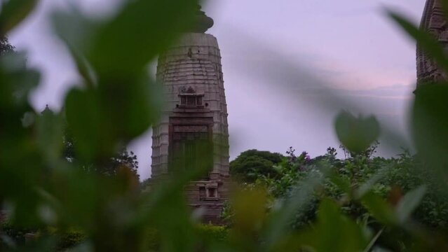 Beautiful View Of Parvati Temple Behind Plants Situated At The Western Complex Of Khajuraho Group Of Monuments In Madhya Pradesh, India. - Selective Focus,  Panning Left
