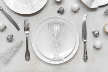 Beautiful table setting with Christmas balls on white background, top view